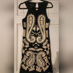 INC women's embroidered ivory & rhinestone detail over a  black sheer layer.